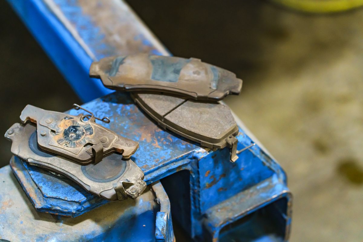 Worn brake pads removed during a brake service
