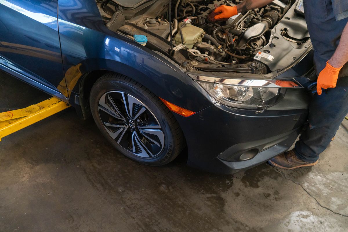 Technician working on a Honda Civic engine