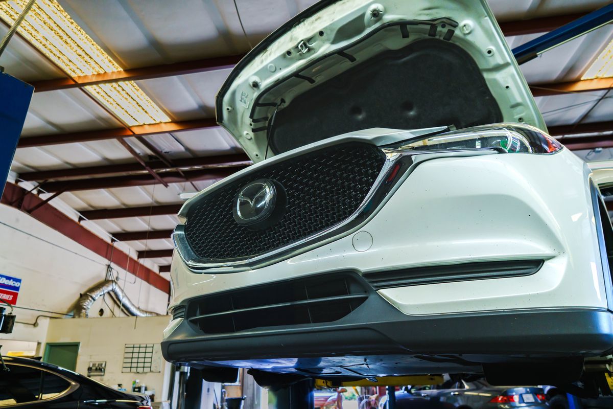Mazda CX-5 on a lift with the hood open