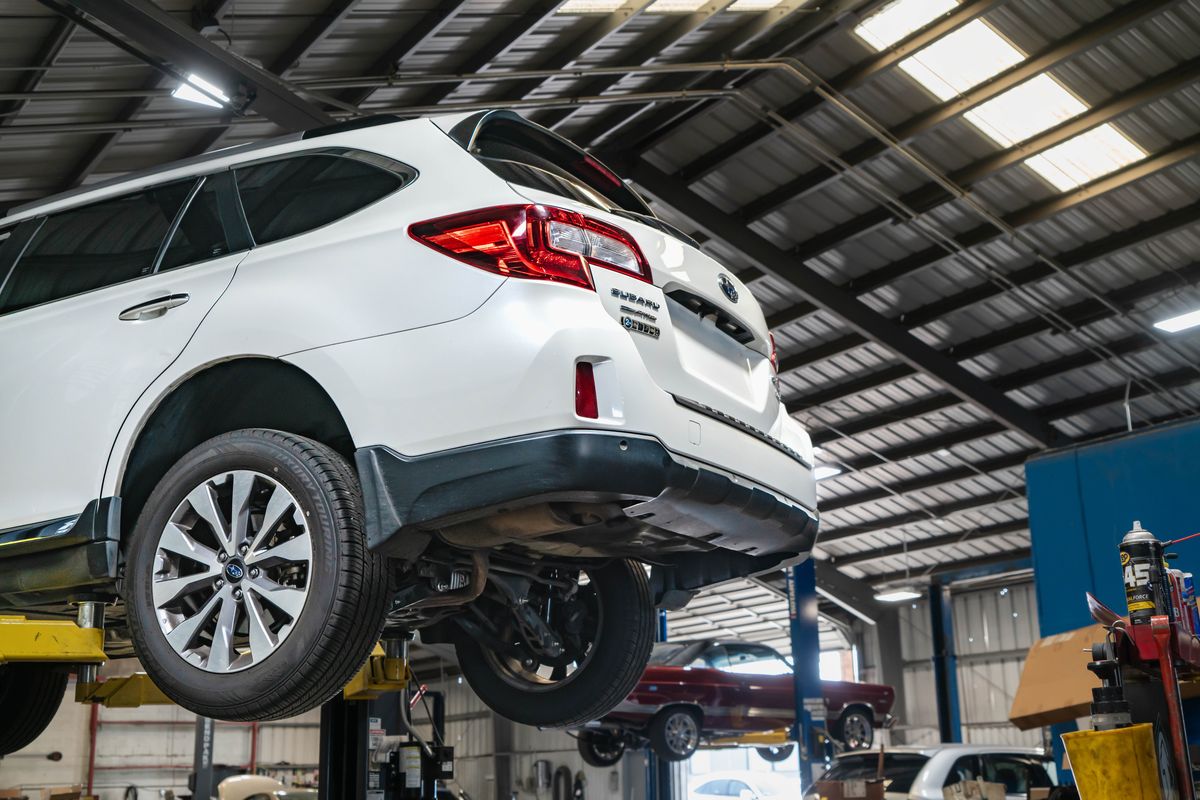 Subaru Outback on a lift at our Sacramento shop